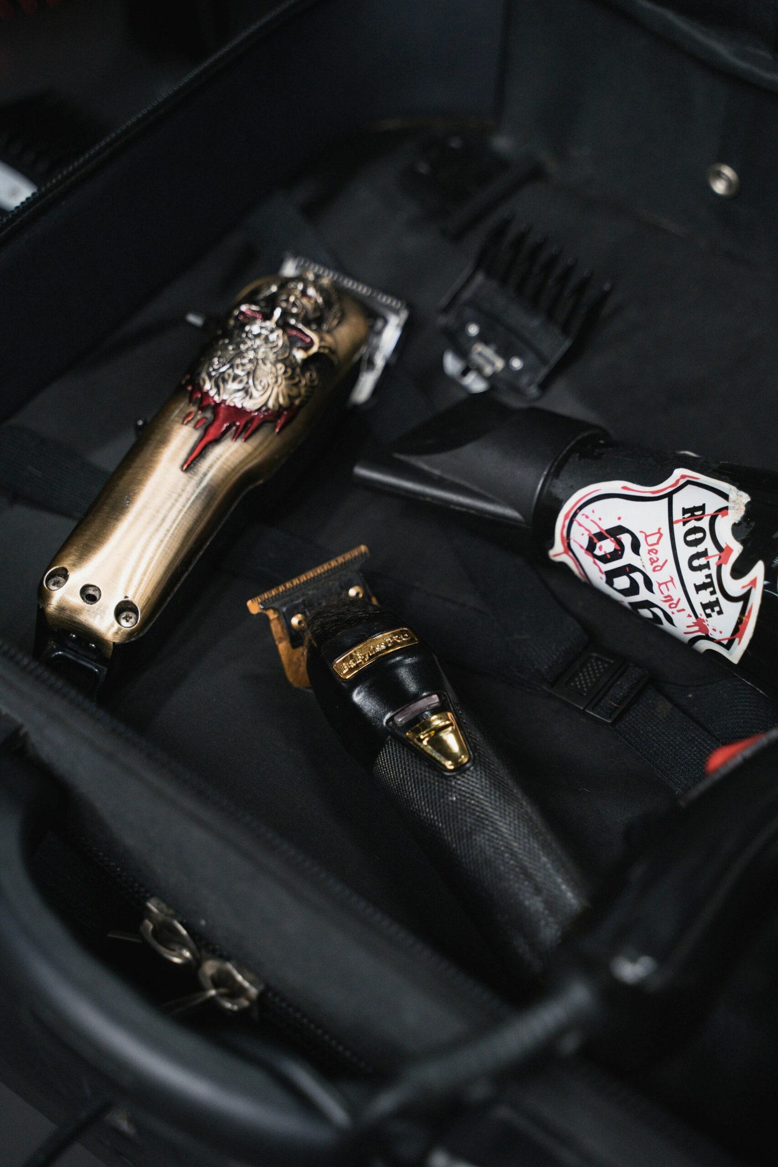 Close-up of professional barber tools in a suitcase, featuring clippers and hair trimmers.