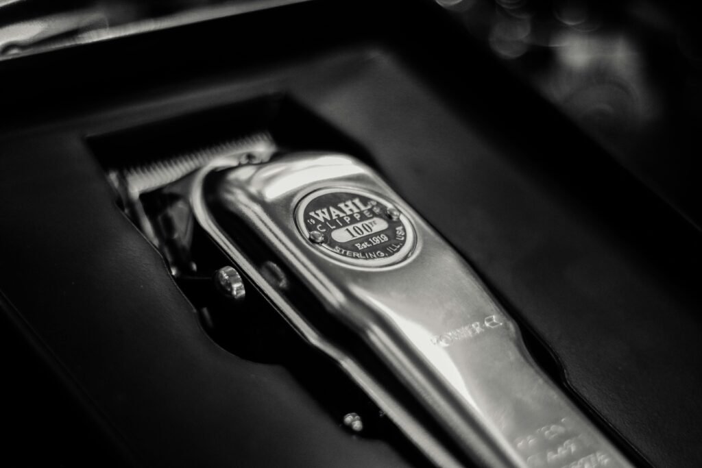 A detailed close-up of a shiny metal cordless clipper in its box, highlighting the sleek design.