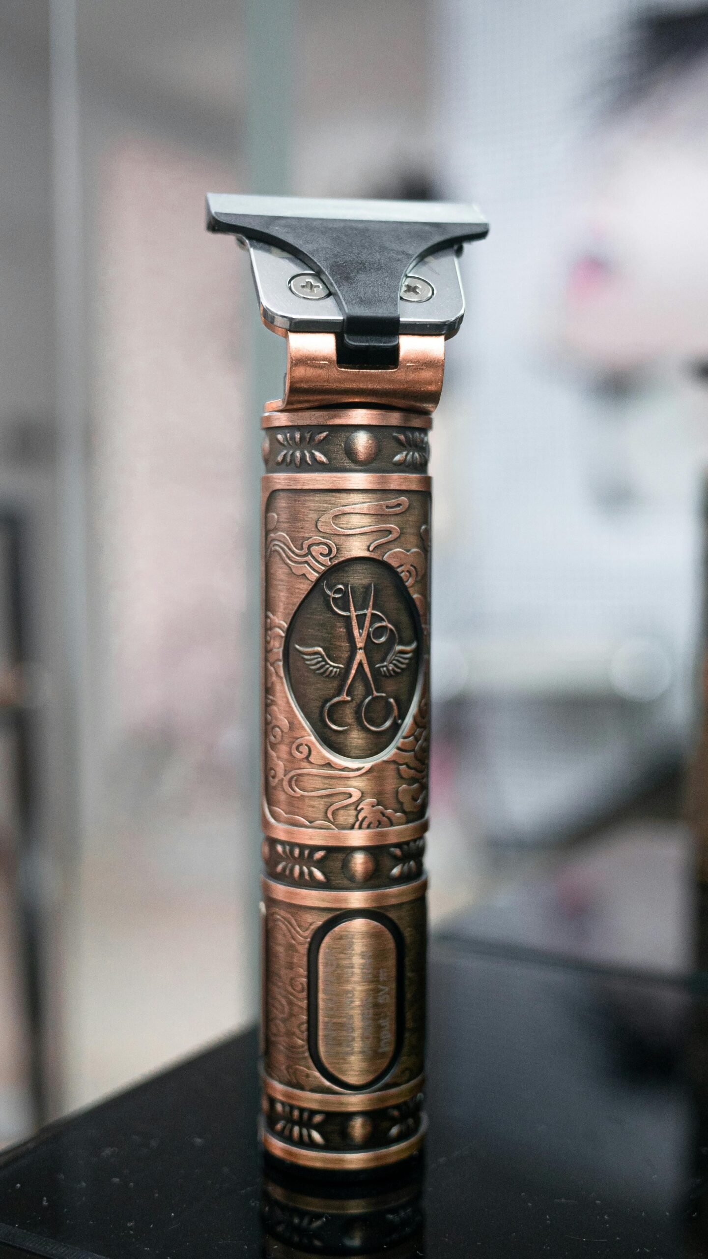 Vintage barber clipper with engraved design in Moroccan barber shop, showcasing traditional artistry.
